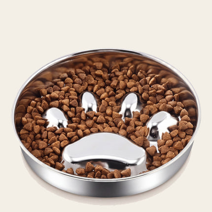 Gamelle ronde en inox garnie de croquettes autour d’un relief en forme d’empreinte de patte