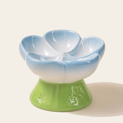 Gamelle en céramique en forme de corolle bleue, vide, sur un pied vert